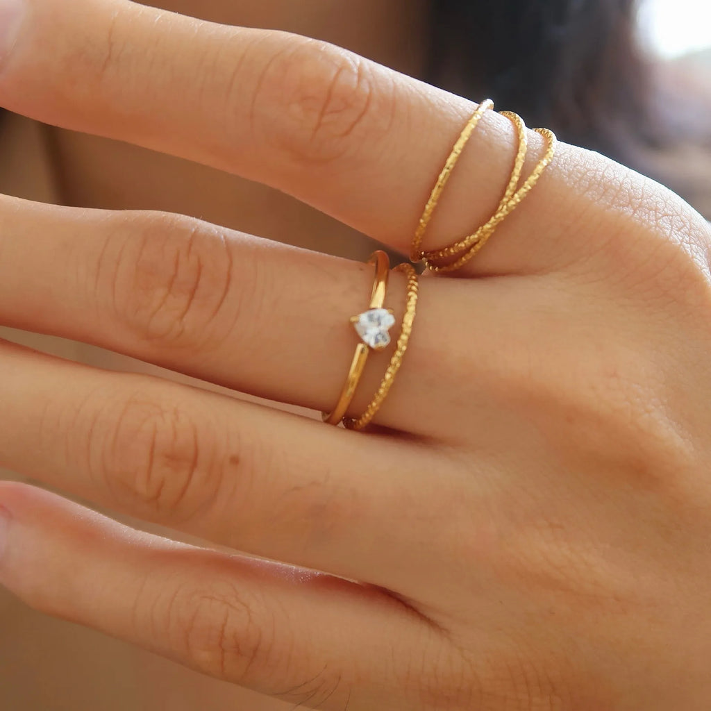 Simple golden stainless steel ring with either love heart or oval shape design in sizes 5 to 8
