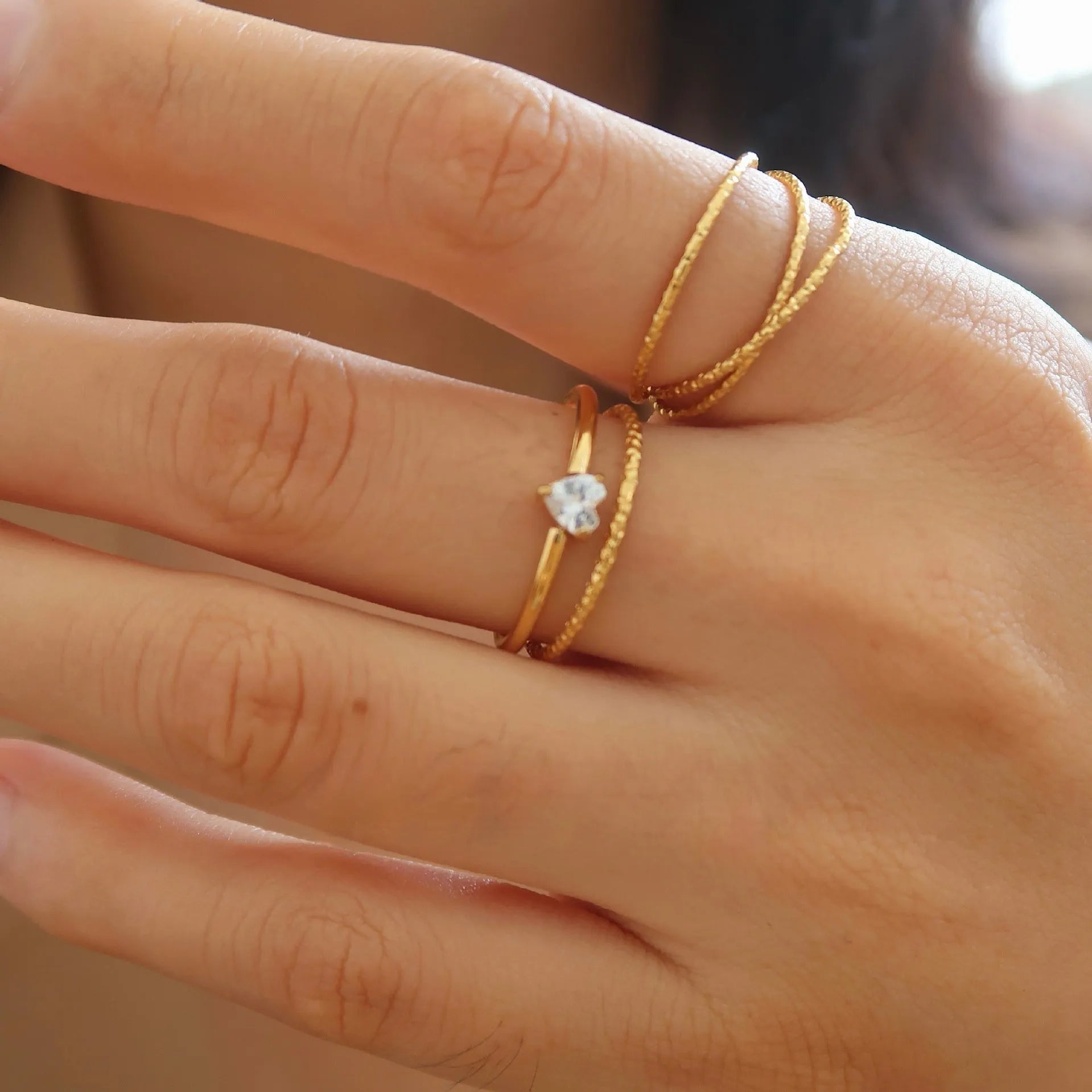 Simple golden stainless steel ring with either love heart or oval shape design in sizes 5 to 8