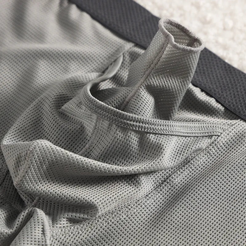 Men's black Ice Silk mesh boxer shorts laid flat, showing low-rise waistband and breathable fabric texture.