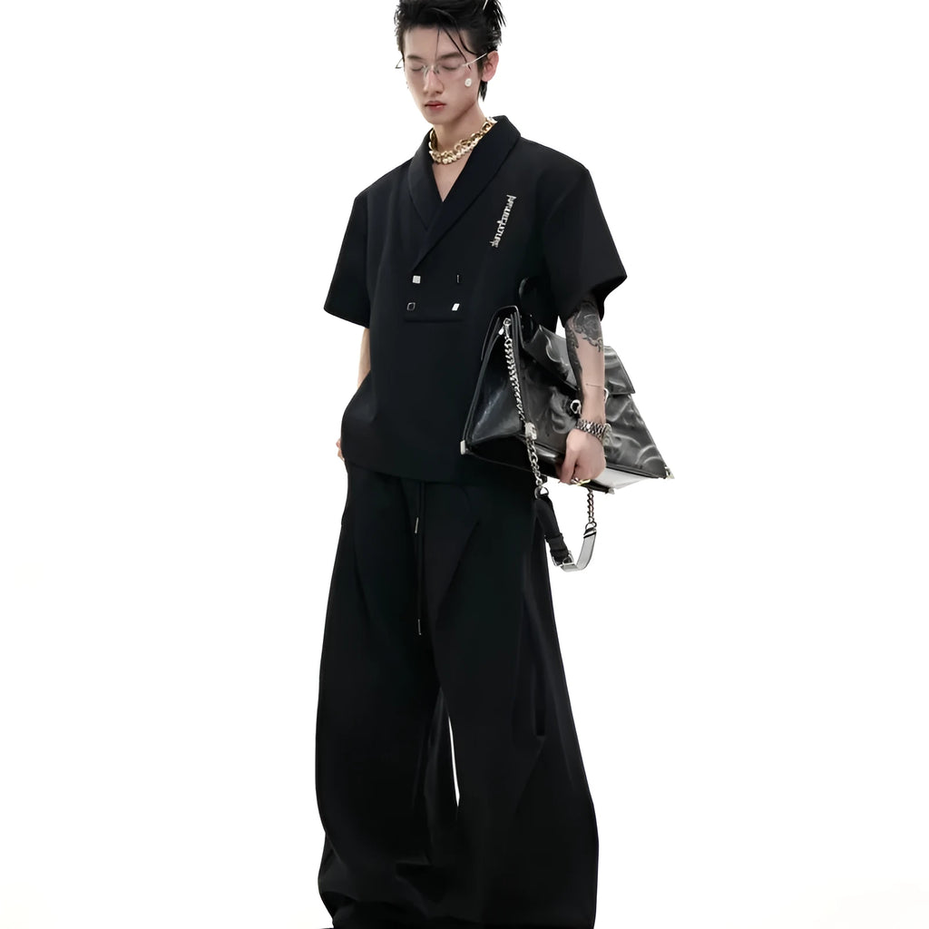 Men's dark grey V-neck padded shoulder sports suit with metal embellishments and matching shorts