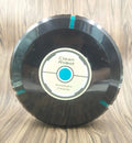Black or white AC automatic sweeping robot on a hardwood floor next to a dust bin.