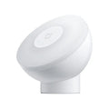 White Mijia Night Light 2 Bluetooth bedside lamp with human body induction on wooden table