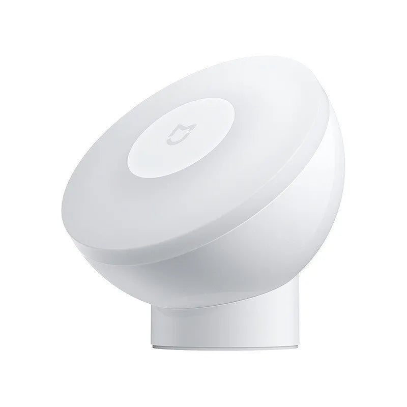 White Mijia Night Light 2 Bluetooth bedside lamp with human body induction on wooden table