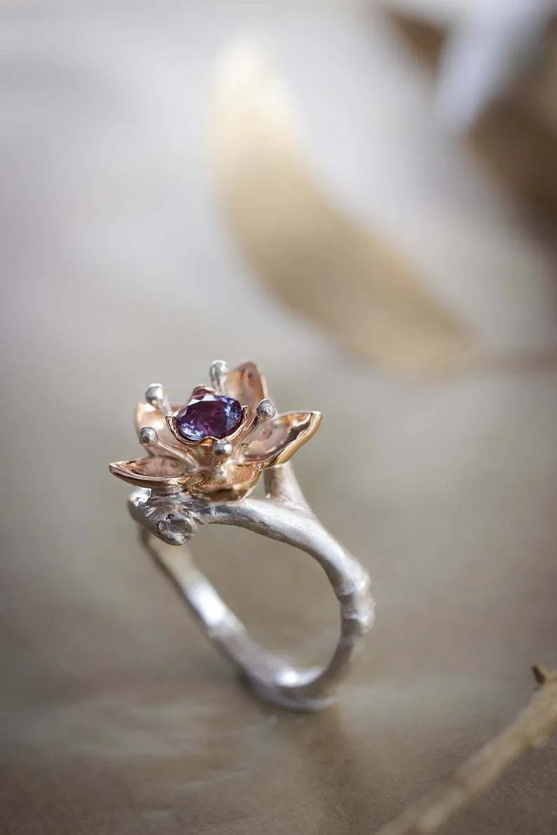 Silver two-tone floral design women's alloy ring on a geometric band.