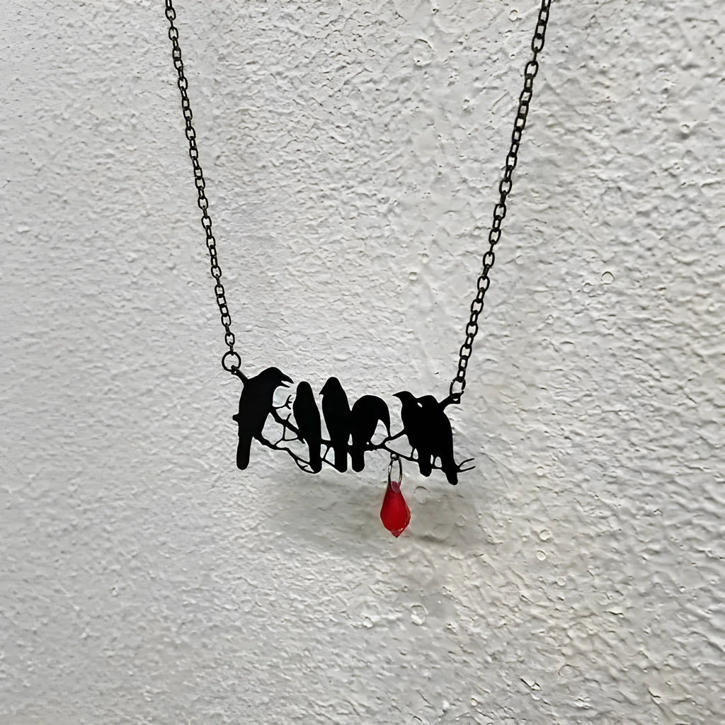 Black alloy crow pendant necklace with electroplated finish and cross chain, gothic bird jewellery.