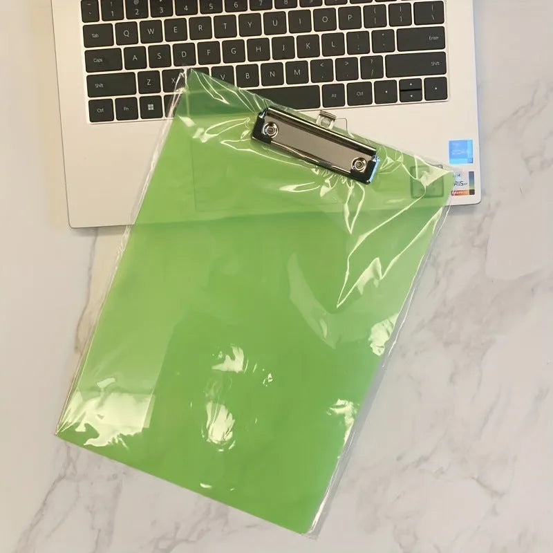 A4 transparent plate holder writing board with metal clip, shown in blue on a desk.