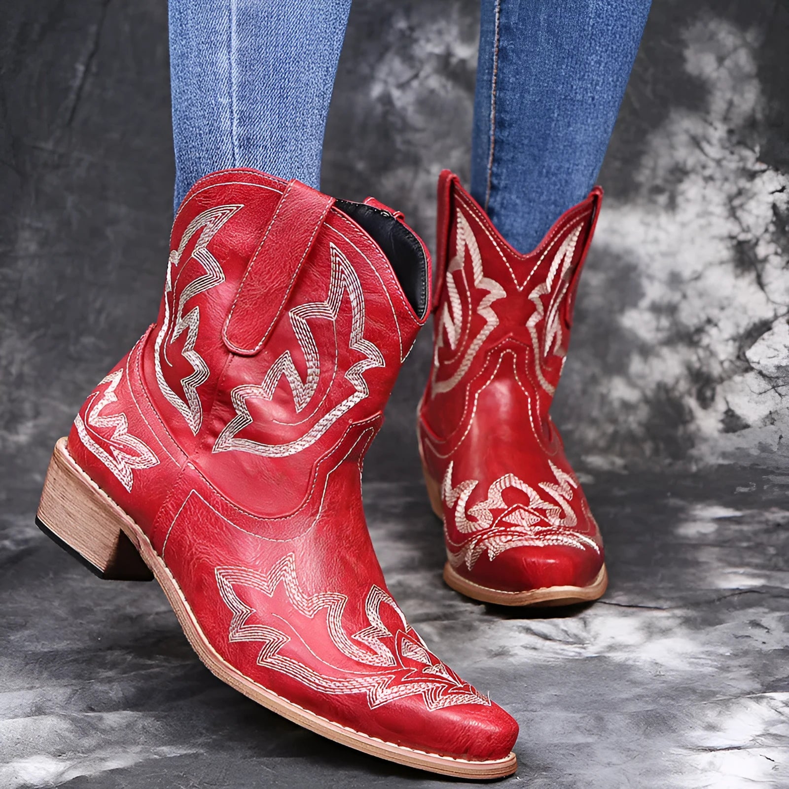 Women's brown cowboy boots with embroidery on the shaft, pointed toe, and a low wedge heel.