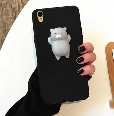 Soft pink silicone TPU phone case with a raised 3D cartoon cat design on the back, fitted to an iPhone.