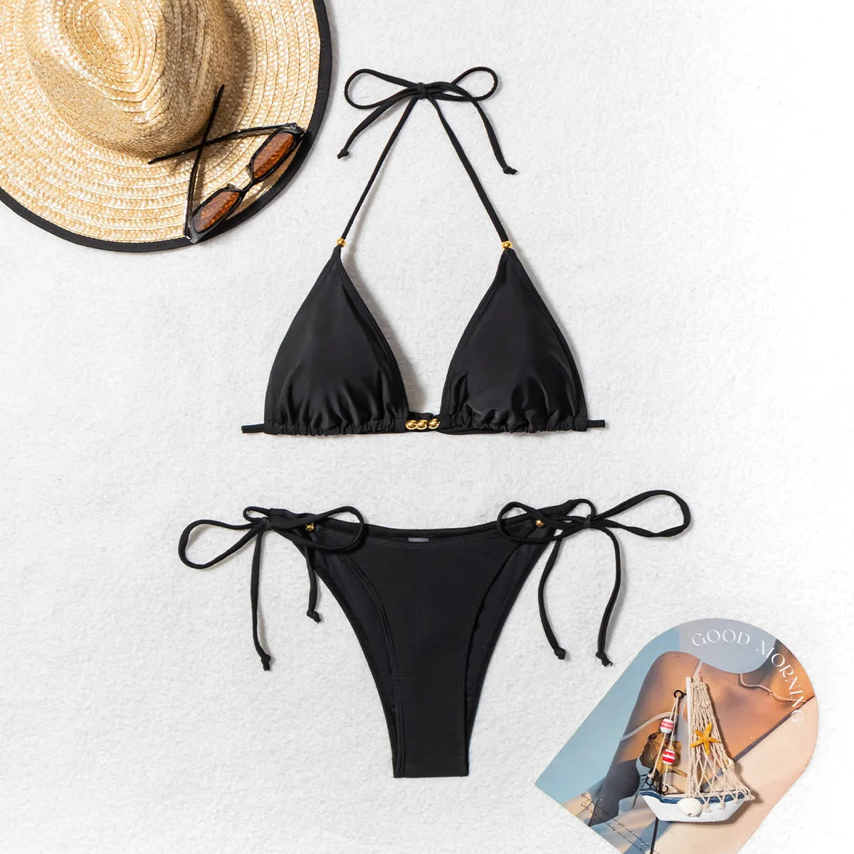 Black women's bikini swimsuit with metal bead decoration on the top.