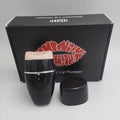 Black and white electric lip plumper device with silicone tip and USB charging cable