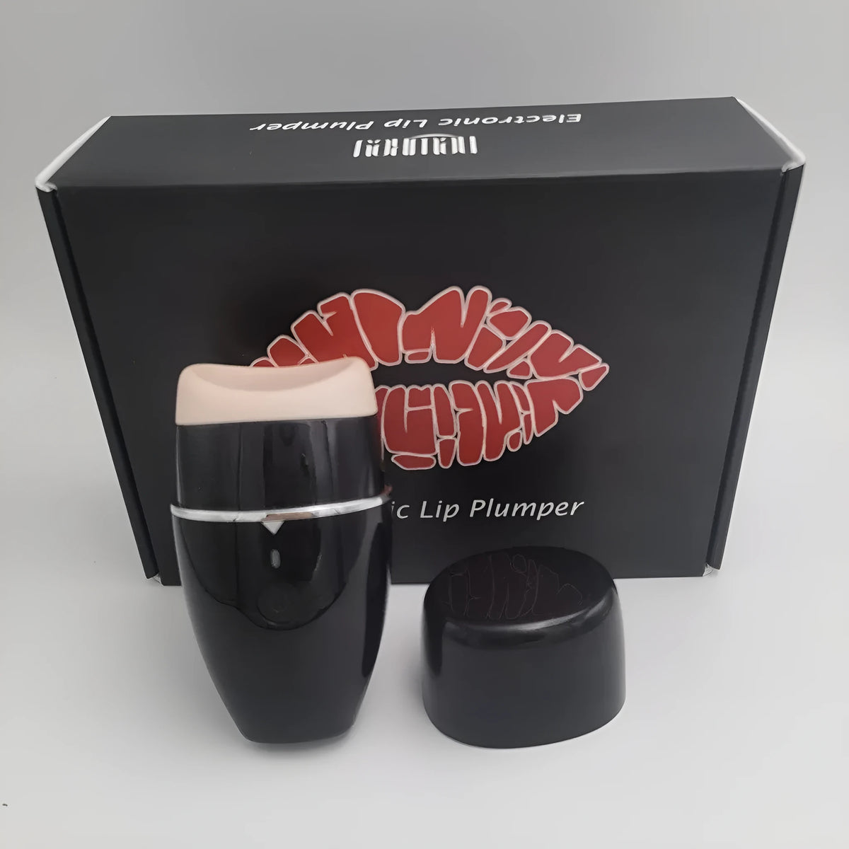 Black and white electric lip plumper device with silicone tip and USB charging cable