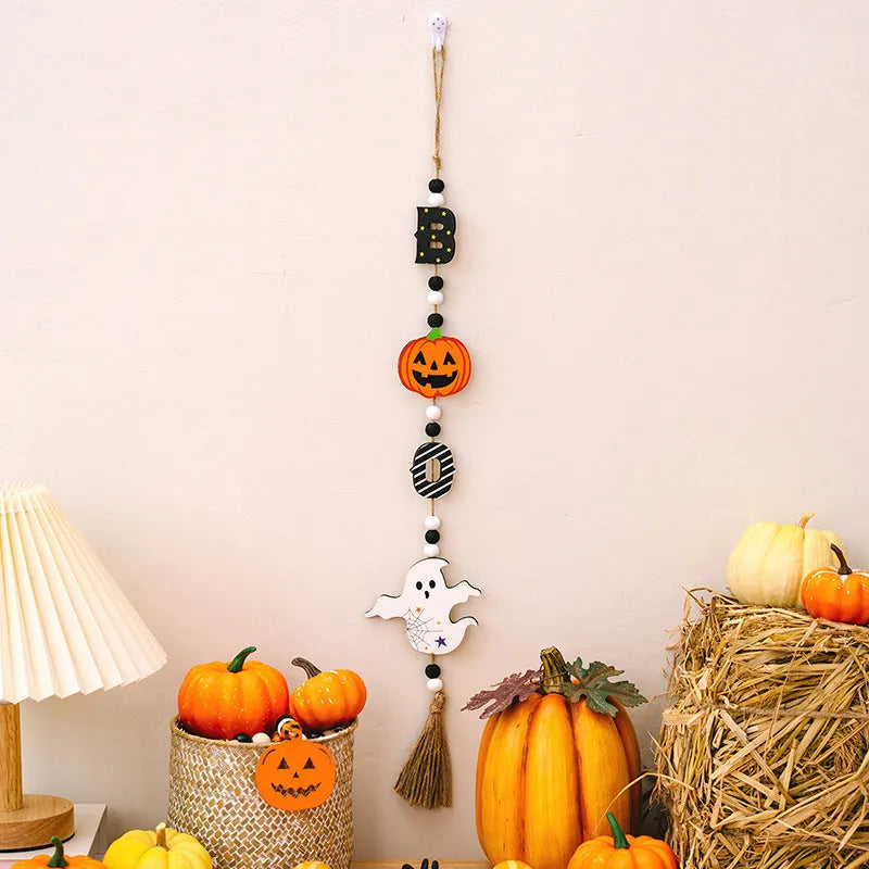 Resin Halloween pendant string with BOO ghost design hanging on a wall