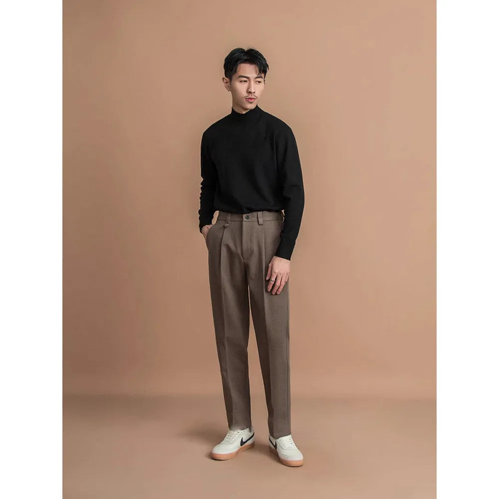 Man wearing straight-fit suit pants in a draped silhouette, suitable for business and casual occasions.