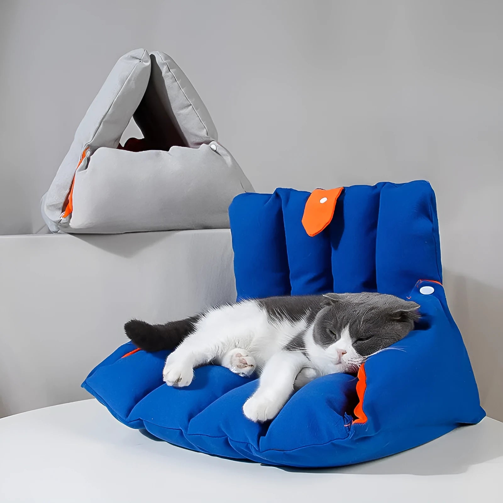 Blue triangular cat nest bed with drilled holes for modular connection and removable cotton cover
