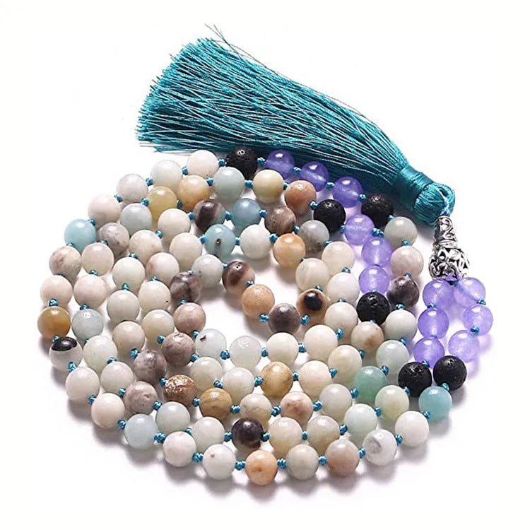 Long agate tassel necklace with geometric beads in multiple natural stone colours on a white background.