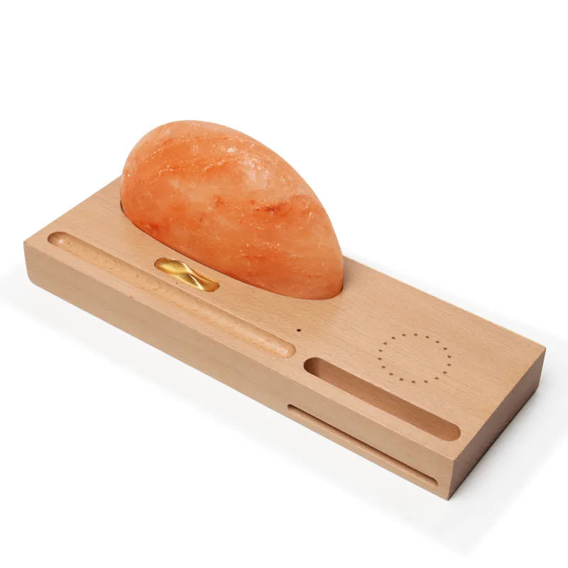 Sunrise Oriental wooden base table lamp with natural crystal salt shade and wireless phone charging pad.