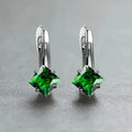 A pair of copper diamond design earrings for women with inlaid zircon stones, shown in blue, green, and a metallic colour.