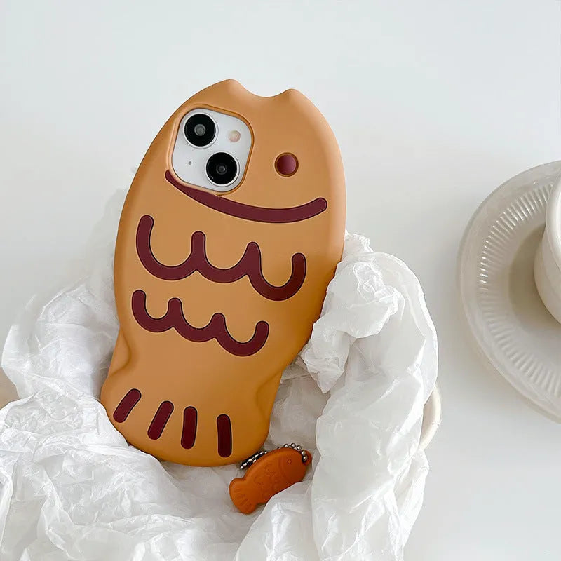 Brown silicone phone case with 3D taiyaki design and hanging ornament for iPhone.