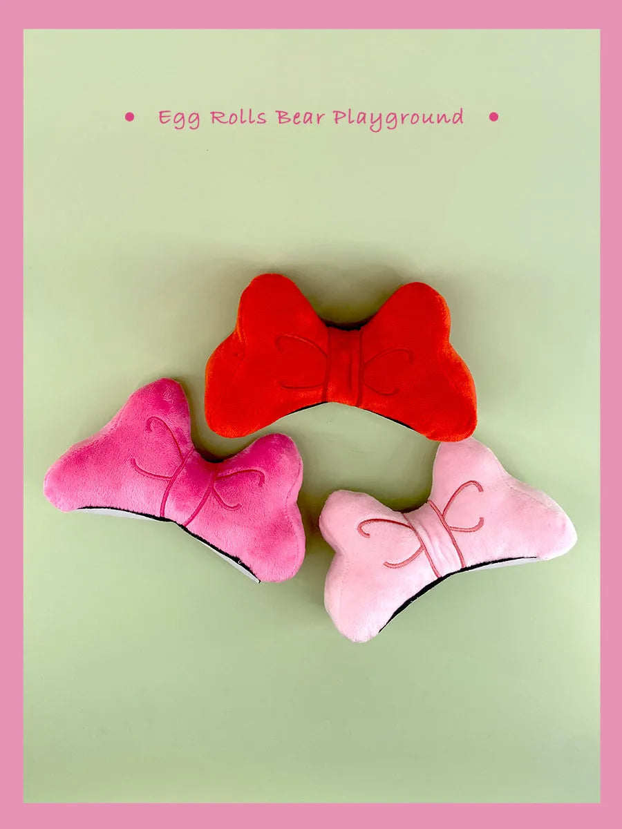 Plush bow tie helmet decoration in red, pink, or rose for motorcycle and ski helmets