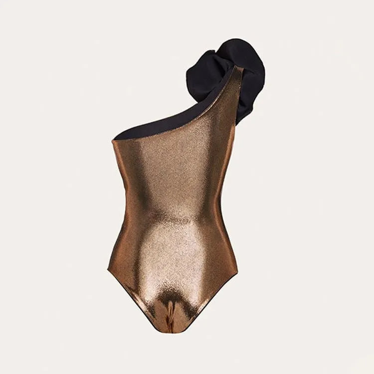 Gold coloured handmade one-piece swimsuit with halter neckline and hollow-out design on a mannequin.