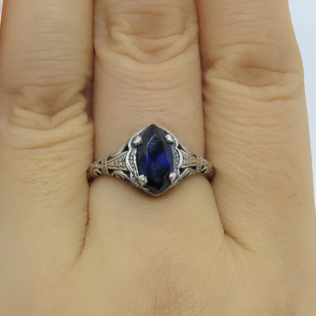 Women's silver geometric hollow ring showing alloy construction and patterned design