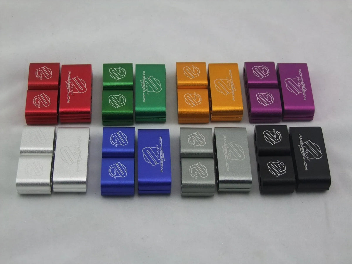 Three-piece metal car modification fastening clamp in assorted colours on a white background.