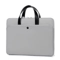 Ultra-thin leather laptop case in light gray with zipper closure and soft handle for 15.6-inch laptop