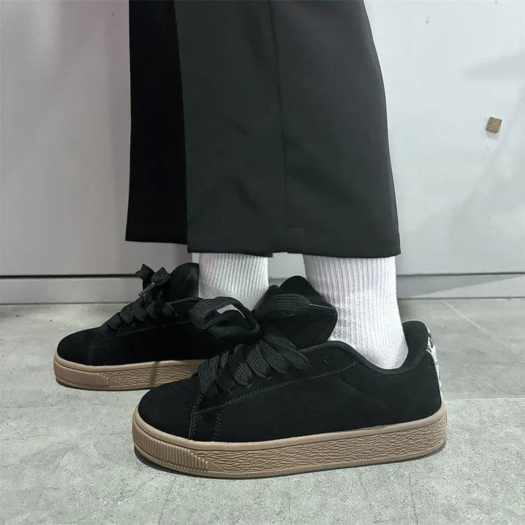 Black retro low-top sneakers with round toe, front lace-up, and waterproof platform sole