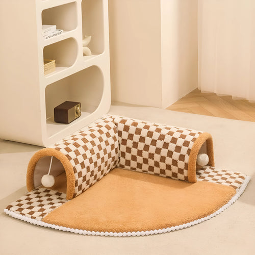 Fan-shaped plush pet bed with central play tunnel in plaid design, shown in coffee colour.