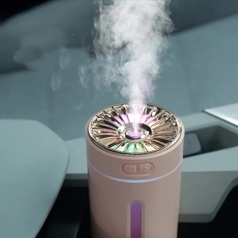 Black and white portable wireless humidifier with LED lights on a car cup holder and desktop