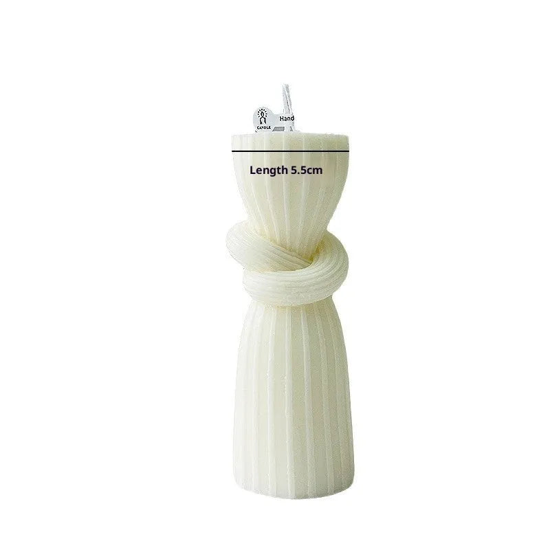 White cylindrical soy wax aromatherapy candle with geometric spherical shape on a table