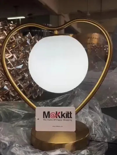 Gold metal base heart-shaped table lamp with clear crystal-cut acrylic shade