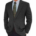 Man wearing a brown herringbone pattern retro-style suit jacket with long sleeves.