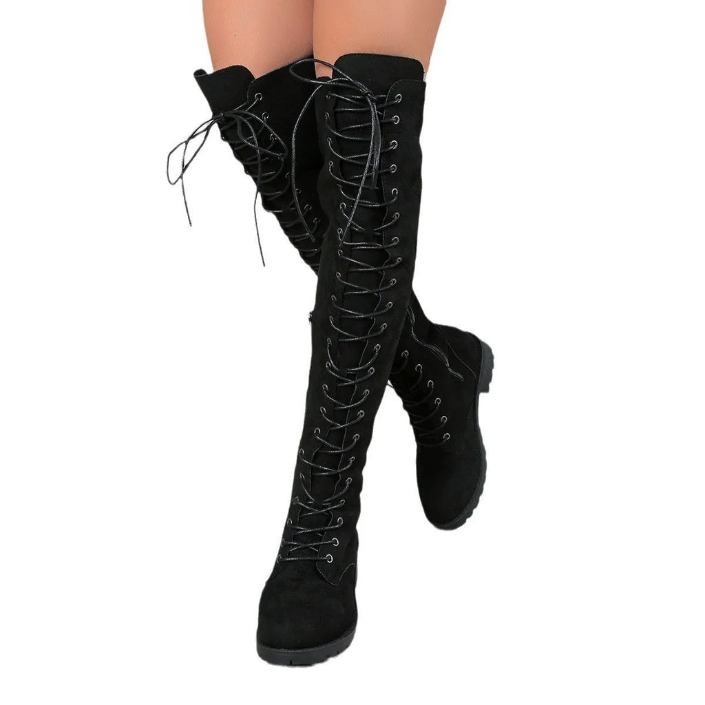 Black lace-up over-the-knee boots with flat heel and round toe on a white background