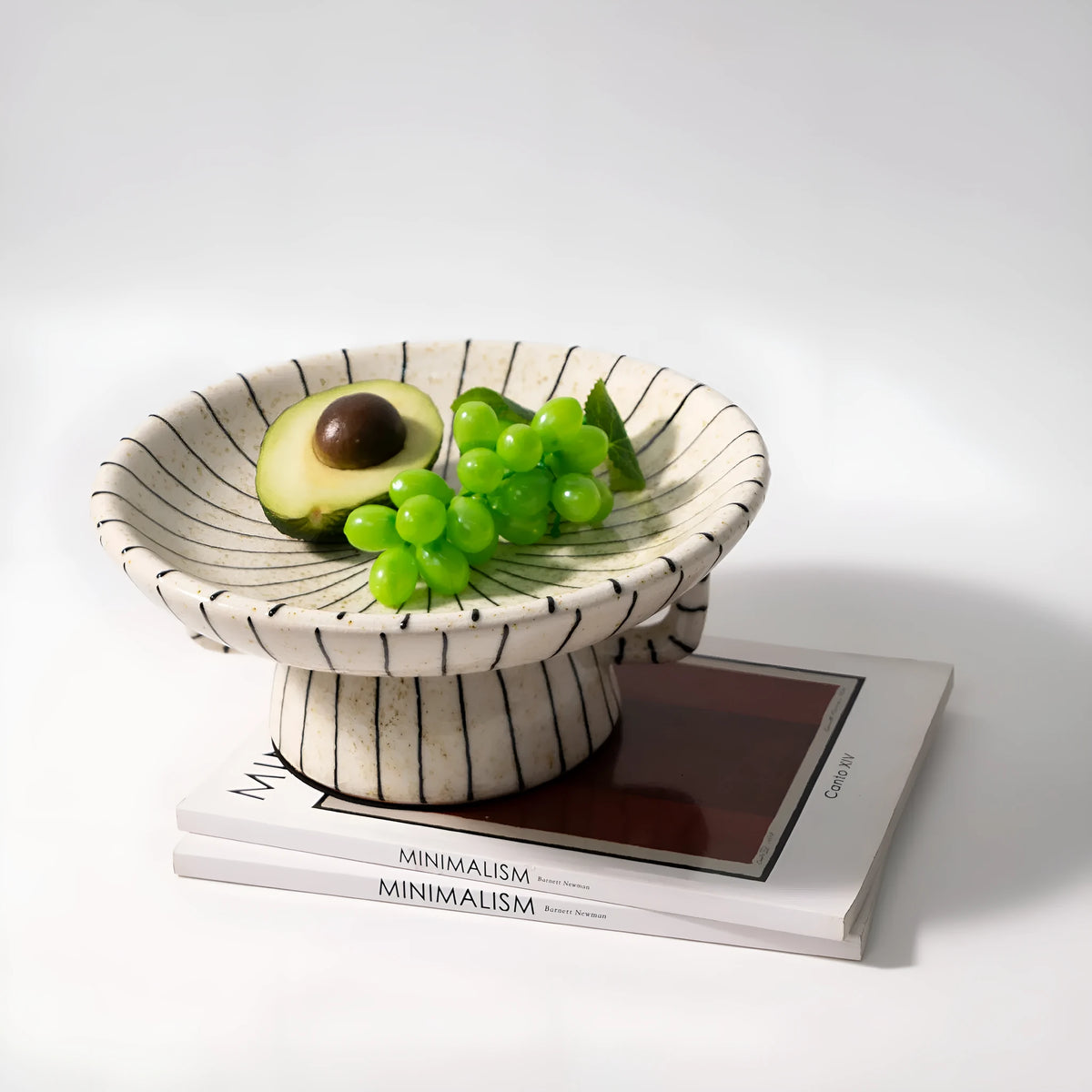 Black and white striped retro fruit plate on table with dessert