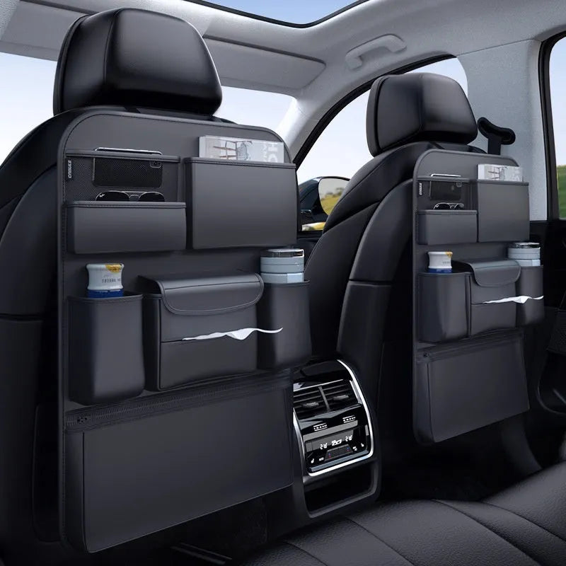 Black leather car seat back storage hanging bag with carrying handle shown attached to vehicle seat