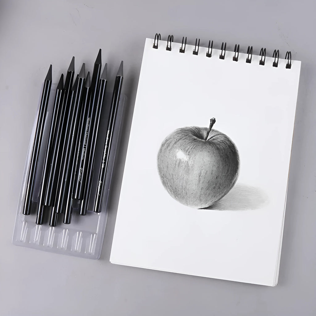 Set of six graphite and three carbonised drawing pencils with wooden shells on suction card packaging.