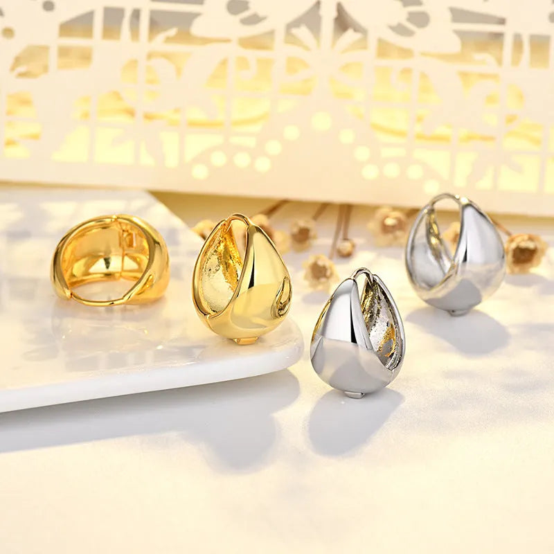 Copper geometric circle ear clips with gold inlay, ellipse and ring shape, shown in gold or white colour options.