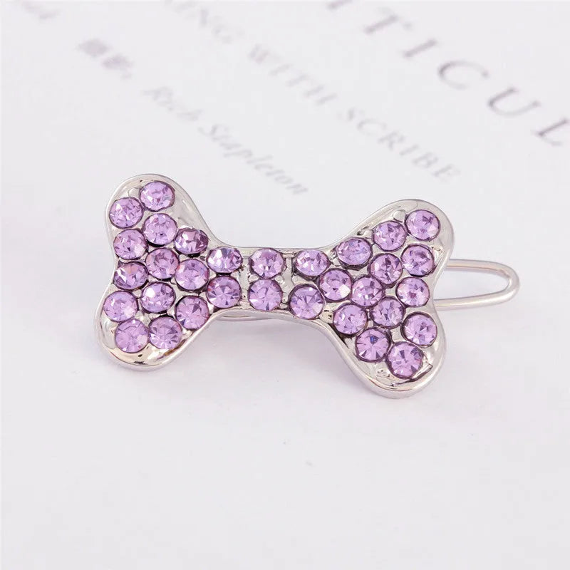 Rhinestone dog bone hair clip in alloy, shown in white, pink, blue, red and purple colour options.