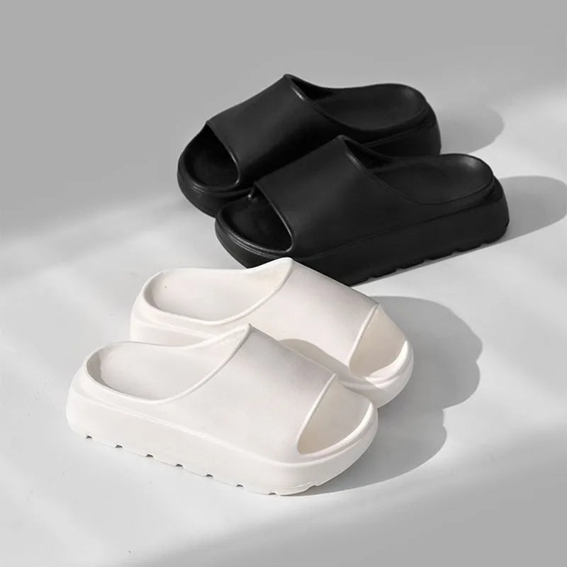Women's beige EVA fish mouth slippers with a thick 5.5cm sole on a tiled floor.