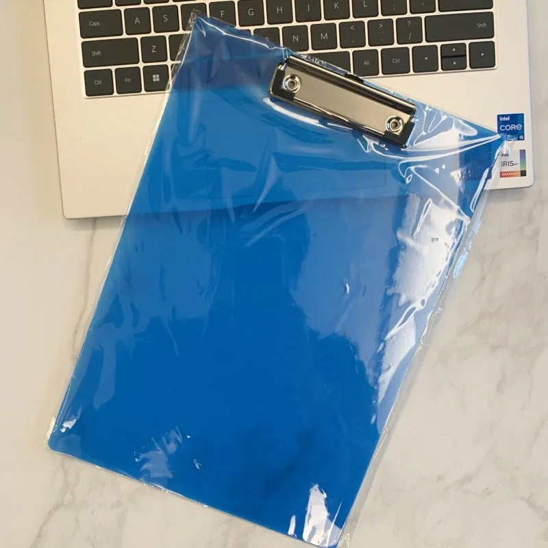 A4 transparent plate holder writing board with metal clip, shown in blue on a desk.