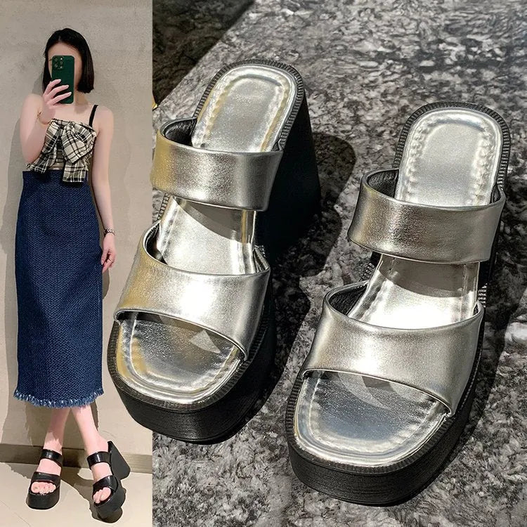Women's black wedge platform slippers with square toe design on grey background