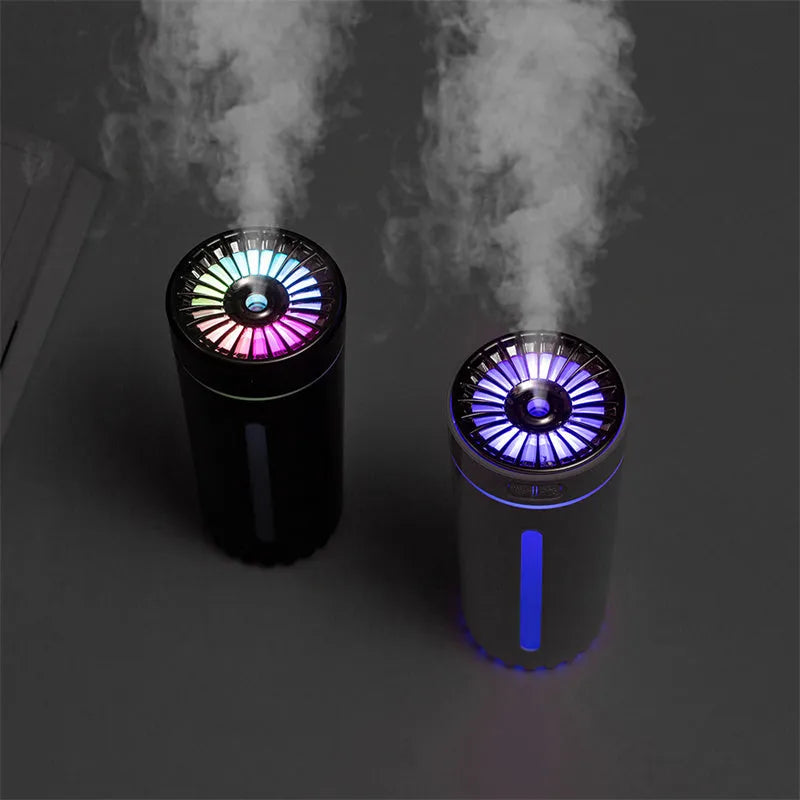 Black and white portable wireless humidifier with LED lights on a car cup holder and desktop