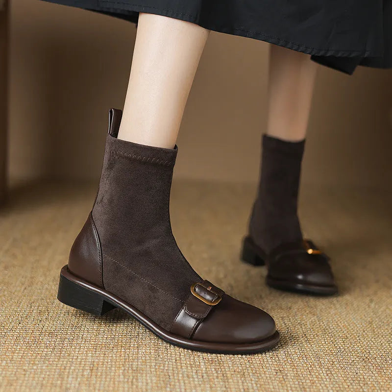 Women's black casual Martin ankle boots with belt buckle stitching and white laces on a rubber sole.