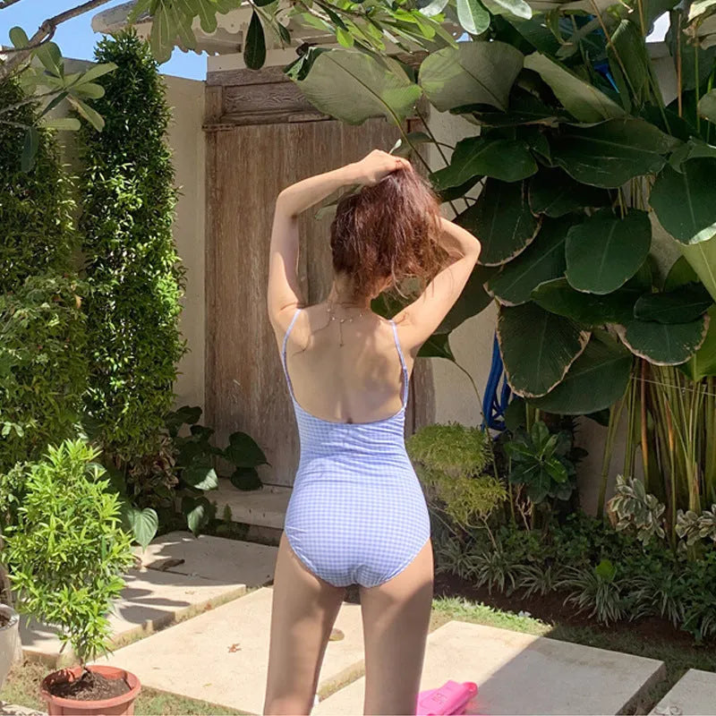 Women's blue and white plaid one-piece swimsuit on hanger showing full front view