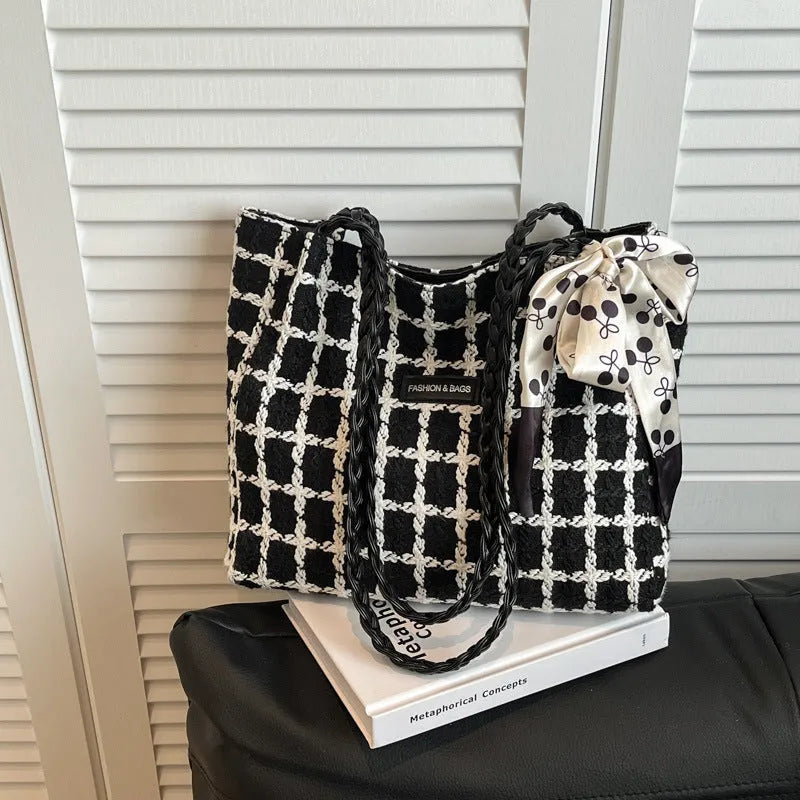 Wool blend shoulder bag in horizontal square shape with organisational compartments and woven sewing details