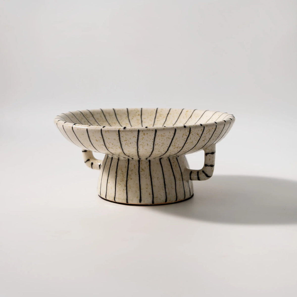Black and white striped retro fruit plate on table with dessert