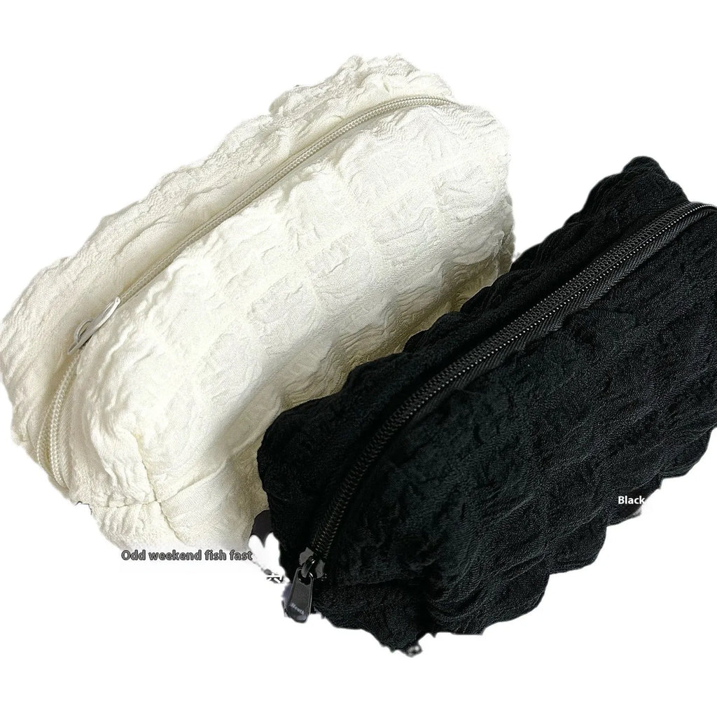 Cream puff style fabric pencil case in beige or black colour made from polyester material