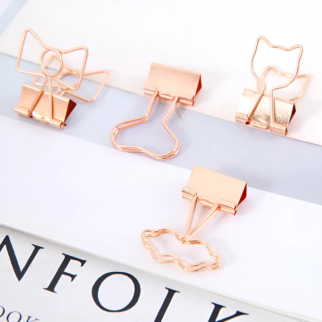 Golden metal stationery clip with a decorative flamingo design on a long tail.