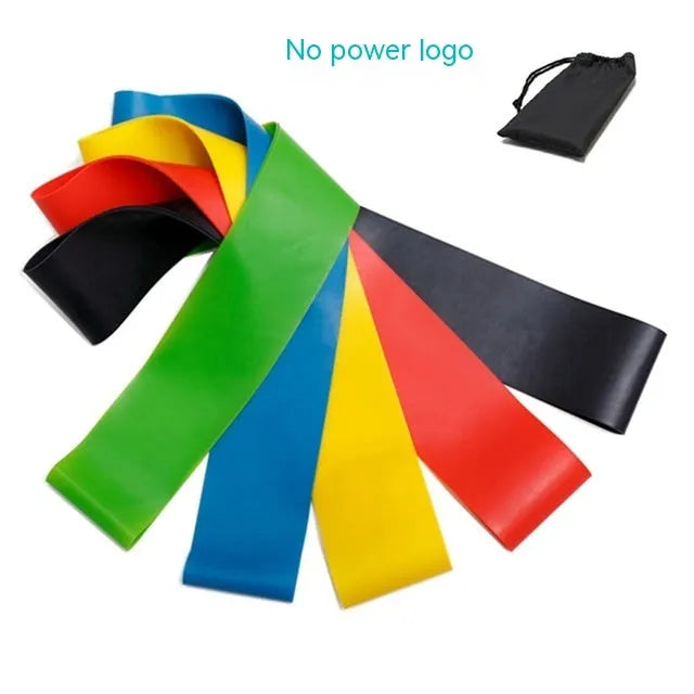 Set of five coloured TPE yoga tension resistance bands with force marks, laid flat showing different thicknesses.